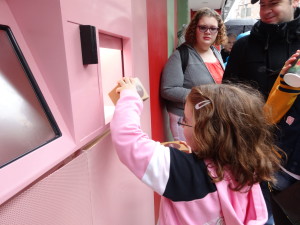Eliza Holland Madore grabs her red velvet cupcake from the cupcake ATM.